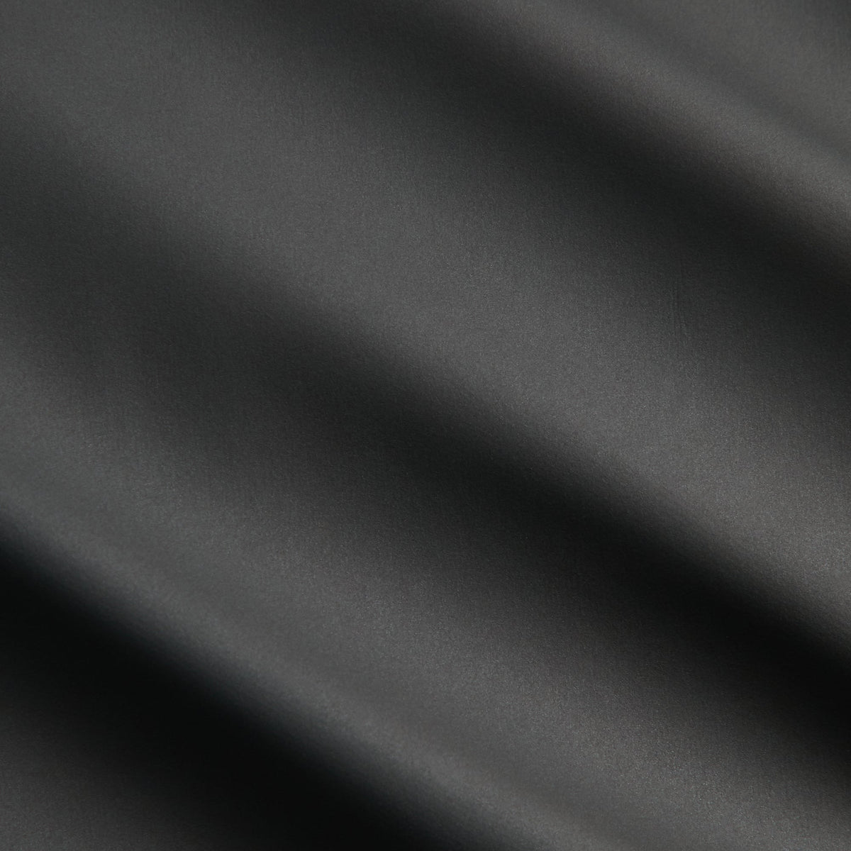 Close-up of black matte poly fabric of the Kith Filmore puffer vest