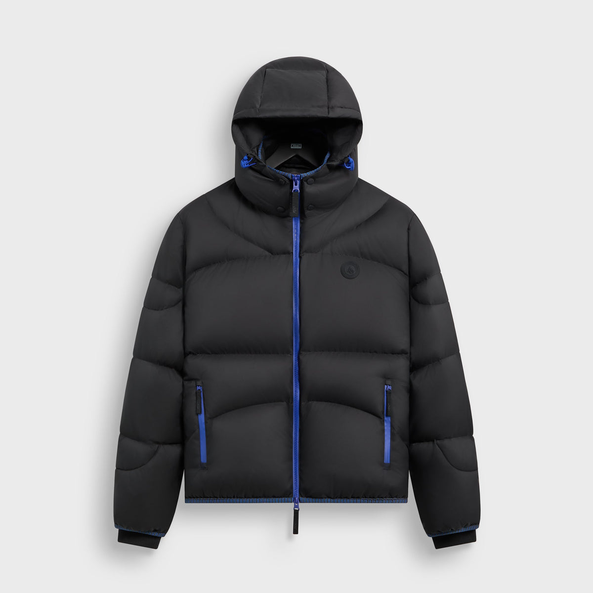 Kith Matte Stretch Taffeta Corey Puffer in black with blue zip accents, front view, hooded puffer