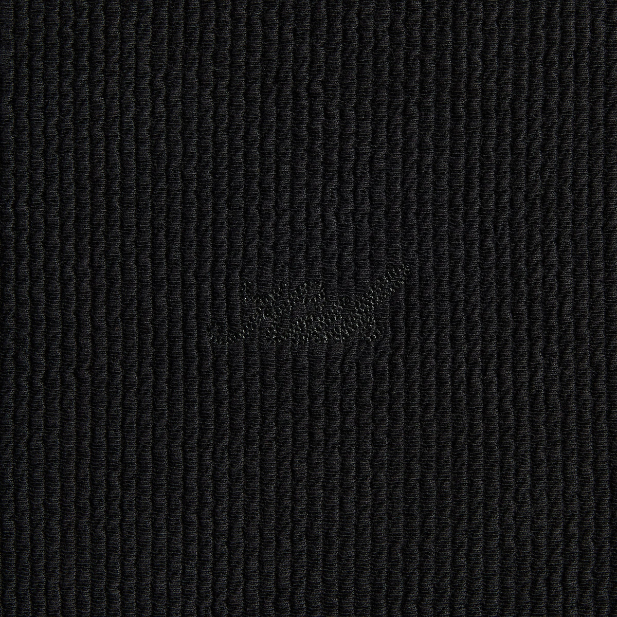 Close-up of the tonal 'Kith' script on the black Heavy Crepe Wilder quarter-zip hoodie