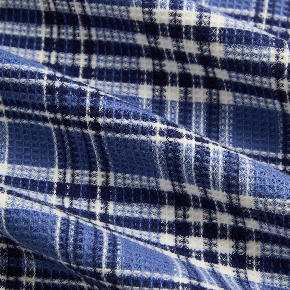 Close-up of the blue and white plaid waffle fabric of the Kith Khenny reversible hoodie