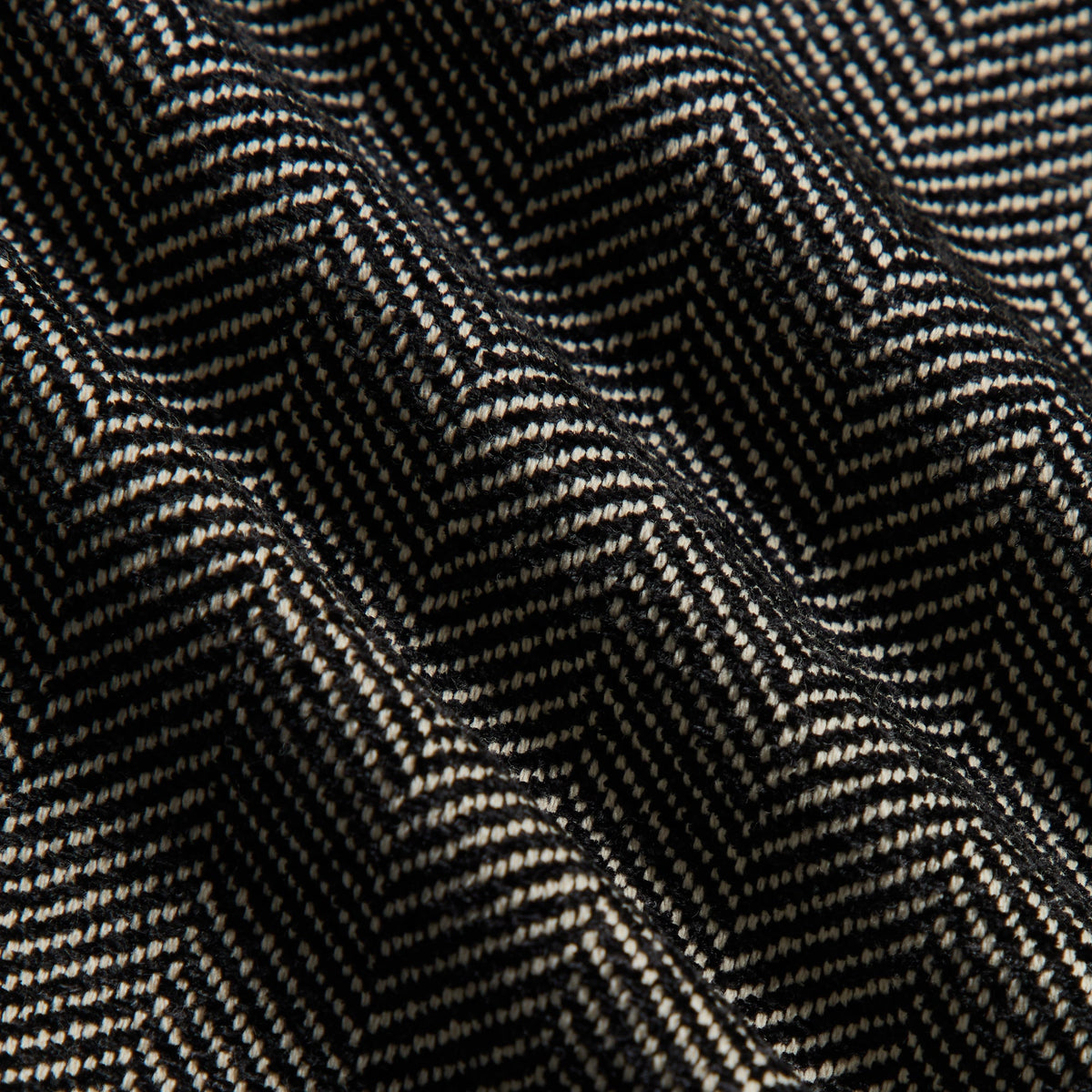 Close-up of the black and cream chenille herringbone fabric of the Kith Grayson pant